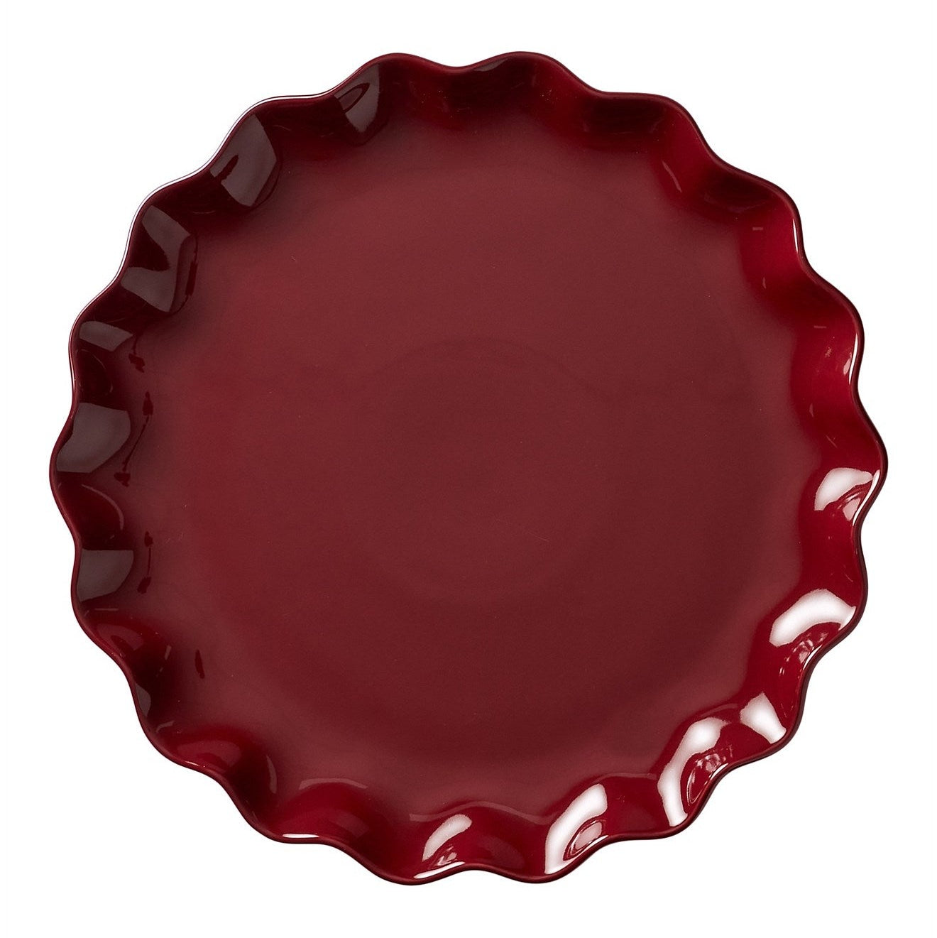 A round glossy ceramic plate with a scalloped rim, shown from a top-down view on a plain white background.